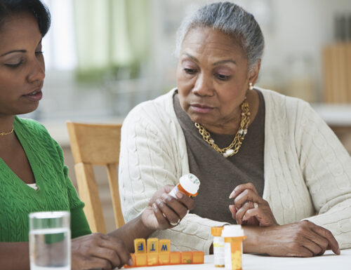 daughter assisting and explaining medicines to mother