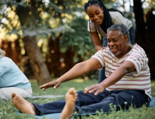 Happy-black-physical-therapist-assists-seniors-during-exercise-class-in-park-1374x1190-1